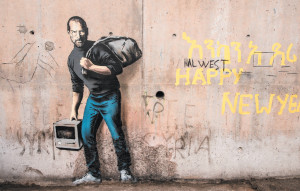Apple founder Steve Jobs as ‘the son of a migrant from Syria’; mural by Banksy,at the ‘Jungle’ migrant camp in Calais, France, December 2015